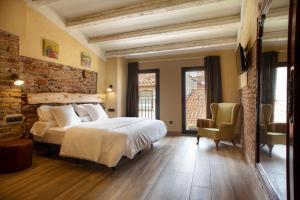 Ein Bett oder Betten in einem Zimmer der Unterkunft Priorat Aparthotel