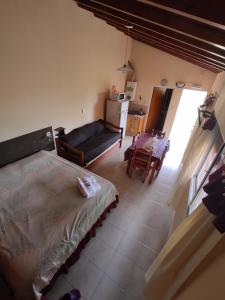 ein Schlafzimmer mit einem Bett und eine Küche mit einem Tisch in der Unterkunft Complejo Turístico Imagine Victoria in Victoria
