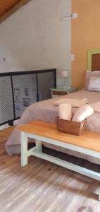 a bedroom with a bed and a table with towels at Balcon de Antares in Uspallata