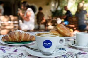 a cup of coffee and croissants on a table at Hotel Vela Velo Club Vieste in Vieste