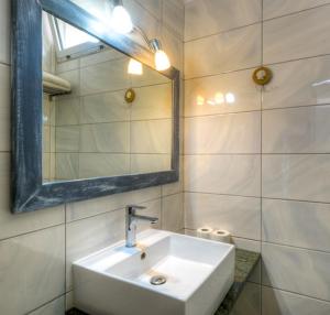 a bathroom with a white sink and a mirror at Hotel Vela Velo Club Vieste in Vieste