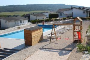 a swimming pool with a swing and a playground at Holiday Villapark - Seaview Albena - Rogachevo - Bulgaria in Rogachevo