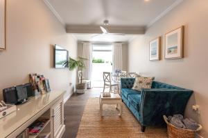 a living room with a couch and a table at Hampton Court in Oneroa