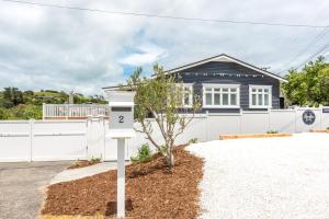 a house with a parking meter in front of it at Hampton Court in Oneroa