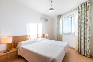 una camera con letto e finestra di La Francesa Algarve a Monte Gordo