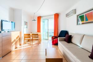 ein Wohnzimmer mit einem Sofa und einem Tisch in der Unterkunft La Francesa Algarve in Monte Gordo