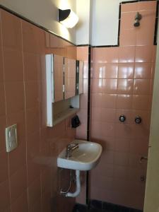 a bathroom with a sink and a mirror at Casa Nanet Hotel in Mar del Plata