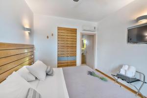 Postel nebo postele na pokoji v ubytování Calma Boutique Hotel