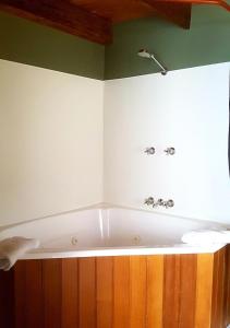 a bath tub in the corner of a bathroom at Red Brier Cottage Accommodation in Richmond