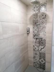 a shower with a glass door in a bathroom at Gîte de Brunemont in Diéval
