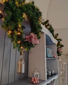 a christmas wreath on top of a cabinet at Casa vacanze San Giovanni nei Sassi in Matera
