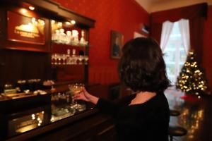a woman standing at a bar holding a wine glass at La Casa Sul Nilo in Naples