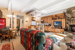 a living room with a couch and a table and a kitchen at Lakeview A-303 - Dillon in Dillon