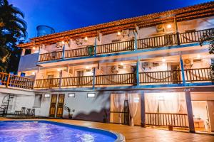 a building with a swimming pool in front of it at Vila Baiana Pousada in Itacaré