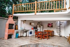 a kitchen with a table and chairs and a staircase at Vila Baiana Pousada in Itacaré