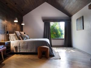 a bedroom with a bed and a large window at Hardwood House in Daylesford