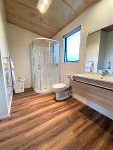 a bathroom with a shower and a toilet and a sink at Country Retreats on Ranzau 8 in Hope