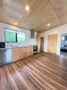 a large kitchen with wooden floors and a large window at Country Retreats on Ranzau 8 in Hope