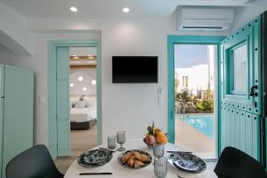 a dining room with a table with food on it at Majo Suites Hotel in Agia Anna Naxos
