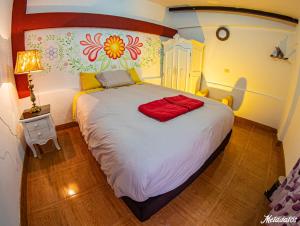a bedroom with a large white bed in a room at Bull House in Urubamba