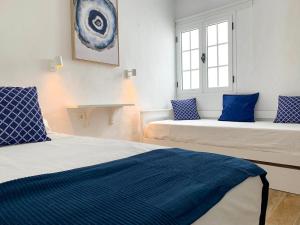 two beds in a room with blue and white at BAHIA LA SANTA APARTMENTS LANZAROTE in La Santa