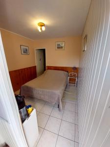 a bedroom with a bed and a tiled floor at Chambres Les Salles in Beauvoir