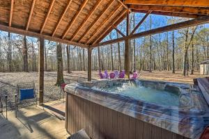 a hot tub in a pavilion with people in it at Pet-Friendly Shady Oaks Broken Bow Gem with Patio! in Broken Bow