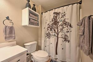 a bathroom with a shower curtain with a tree on it at Pet-Friendly Shady Oaks Broken Bow Gem with Patio! in Broken Bow +24 photos