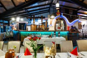 a restaurant with white tables and chairs and a bar at Hotel Restauracja Browar Lwów w Lublinie in Lublin