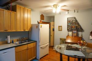 a kitchen with a white refrigerator and a table at Downtown Doylestown - walking distance to restaurants shops and Starbucks in Doylestown
