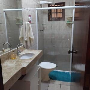 a bathroom with a sink and a toilet and a shower at Casa Pousada Cantinho Secreto in Ubatuba