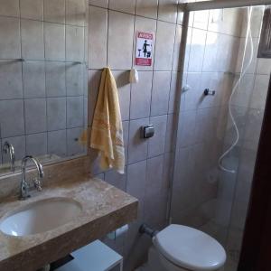 a bathroom with a sink and a toilet and a shower at Casa Pousada Cantinho Secreto in Ubatuba +20 photos