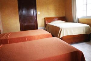 Voodi või voodid majutusasutuse Canal Inn Panama toas