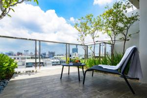 a balcony with a chair and a table with a view at Norway Forest Motel - Wen Chuang Branch in Taichung