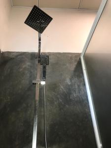 a shower in a room with a black floor at Villa Sea Side Beruwala in Beruwala