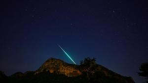 a jet trail in the sky over a mountain at Jing Jo Boutique Bungalow in Sam Roi Yot