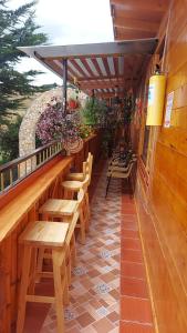 a restaurant with wooden tables and benches on a patio at Villa Evelia in Aquitania