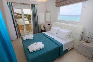 A bed or beds in a room at Paralia Luxury Suites