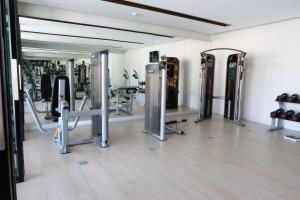 a gym with a bunch of equipment in a room at Season Five Hotel "SHA Certified" in Pattaya