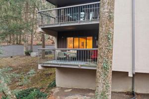 a house with a balcony on the side of it at Superb Gatlinburg Condo with Pool Table and private balcony with stream views in Gatlinburg