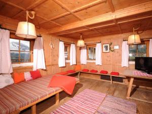 a living room with a couch and a tv at Ferienhaus Martlerhof in Tux
