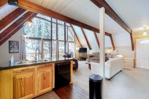 a kitchen with a sink and a living room at Cozy Cabin Retreat in South Lake Tahoe
