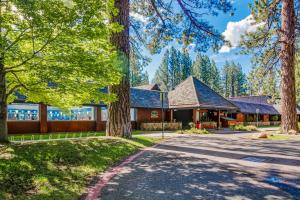a home in the woods with a driveway at Cozy Cabin Retreat in South Lake Tahoe