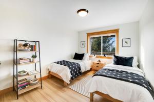 a bedroom with two beds and a window at Three Capes Bungalow in Oceanside +40 photos