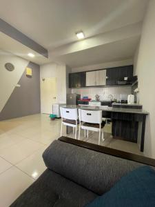 a kitchen with a table and chairs in a room at Pool View Water Theme Park at Swiss Garden Residence - 2 bedroom apartment in Kuantan