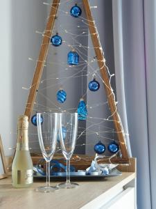 a christmas tree with blue balls and wine glasses at New apartment ViVaNo VAL with amazing view in Zambratija