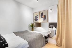 a bedroom with two beds and a mirror at Sanders Leaves - Cute One-Bedroom Apartment With a Large Rooftop Terrace in Copenhagen