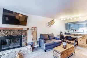 a living room with a couch and a fireplace at Copper Valley 107 in Copper Mountain