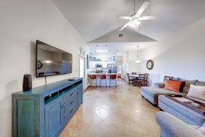 a living room with a couch and a tv at Love & Luck in Corpus Christi