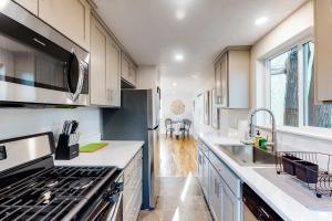a kitchen with white cabinets and a sink at Pearl Place in Eugene